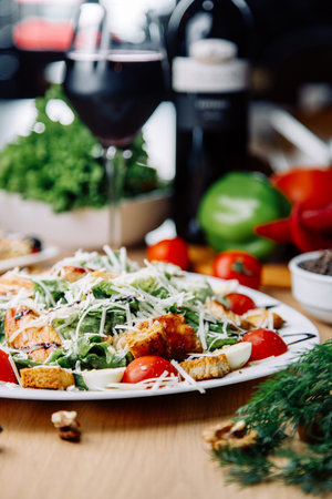 Restaurant serving dishes on a plate. Healthy Caesar salad of chicken with tomatoes and croutons.の写真素材