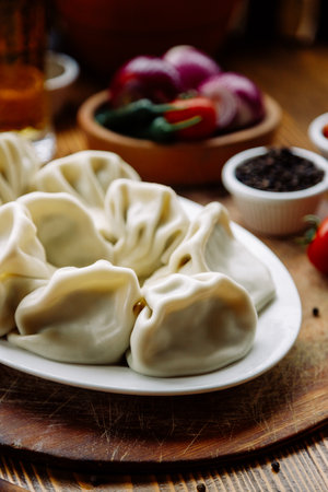Khinkali - traditional Georgian cuisine, Caucasian Armenian cuisine. Homemade dumplings with meat, herbs on a wooden table.の写真素材