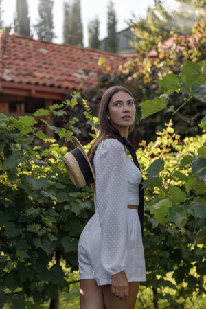 A Charming Young Woman Captured in Nature Surrounded by Vintage Elements and Beautyの写真素材