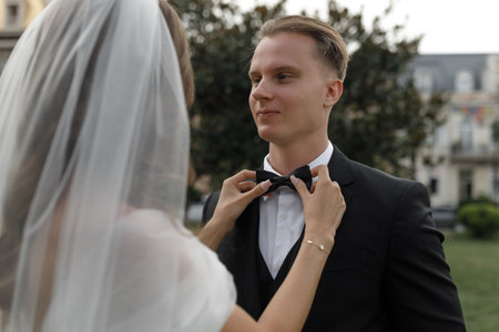 A stunning and beautiful couple enjoys and shares a wonderfully romantic moment in an enchanting garden settingの写真素材