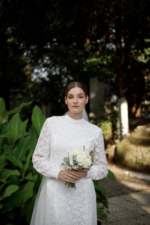 An Elegant Bride in Nature Capturing a Moment of Pure and Timeless Beauty Outdoorsの写真素材