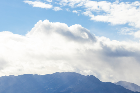 Mountain range in clear weather in contrasting rain clouds before the rain. Beautiful picturesque landscape, stunning positive view, travelの写真素材