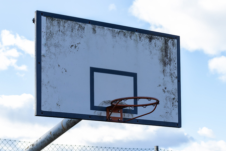 Old street basketball ring against the skyの写真素材