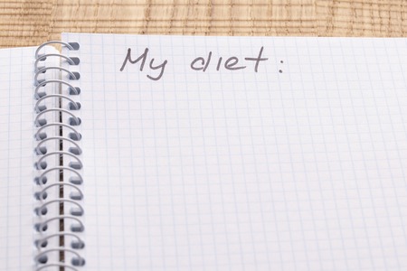 Top view workplace notebook and pen on wood table background, retro effect. Inscription - My diet. The concept of healthy eating and sports lifestyleの写真素材