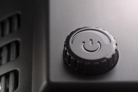 Black plastic power on off button with power adjustment. The concept of modern technologyの写真素材