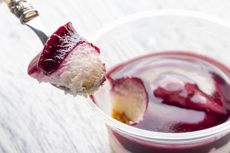 Tiramisu with the addition of blueberries in a plastic jar. Broke a piece of dessert spoon. Close-upの写真素材
