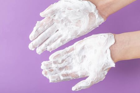 The hands of a teenager are treated with white cream. The concept of the protective properties of...