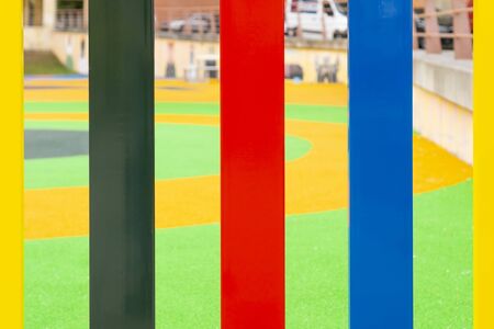 Bright multi-colored fence of a playground for children close-up. Safe rides concept for kidsの写真素材