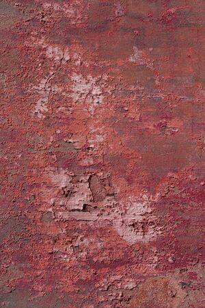 Rusty damaged cement wall with peeling paint and stains. Red brown abstract dramatic colorful...