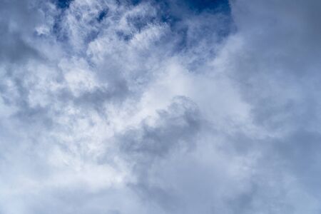 Bright cumulus clouds on a blue sky. Cloudy summer weather