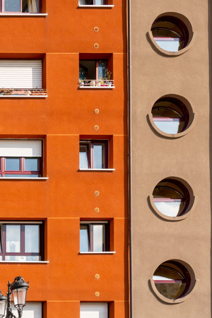 Oviedo, Spain, Asturias - August 2020: Bright facade of a residential building. Geometric shapes. Rectangular and round windows. Abstract conceptのeditorial素材