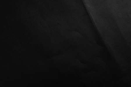 Crushed black paper dark abstract backgroundの写真素材