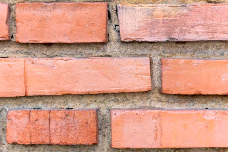 Old brick wall with weathered details close upの写真素材