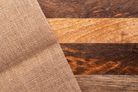 Rough burlap background on wood texture. Copy space.