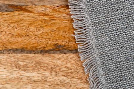 Jute cotton rough woven gray mat texture on a wooden textured rustic surface. Copy spaceの写真素材