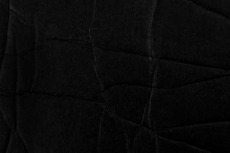 Black fractured crumpled paper surface. Broken cardboard. Abstract backgroundの写真素材