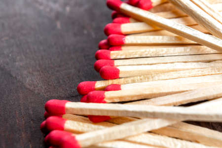 Matches with red sulfur on a dark wooden background. Macro. Extreme close-upの写真素材