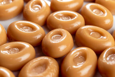 Caramel sweetmeat candies with creamy chocolate flavor. Macro. Selective focus. Brown butterscotchの写真素材