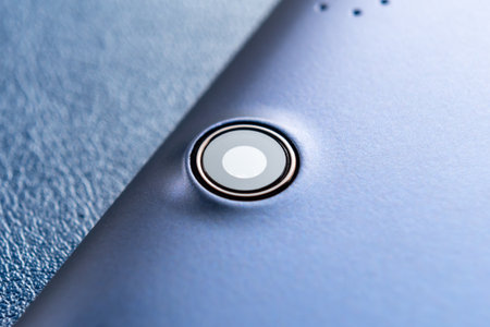 tablet camera lens close up. digital device. macro shot. On blue background