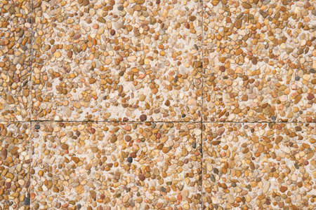 Road tiles with brown pebbles. Small marine stones. close-up. copyspace. abstract texture backgroundの写真素材