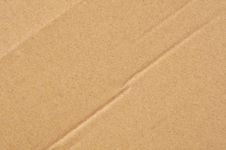Wrapping paper crease. Wrinkled brown texture. Crumpled abstract background