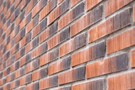 Brick red wall texture. Exterior decorative rough surface of the facade of the building. close-up