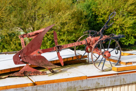Vintage metal plow with wheels for tillage. Antique agricultural equipment for plowing the soil. close upの写真素材