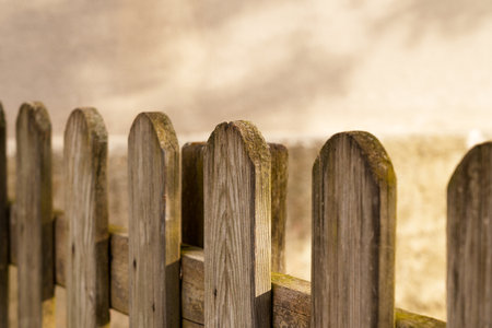 Wooden plank fence with shadow on cement wallの写真素材
