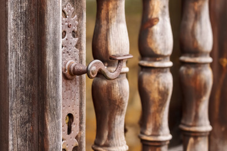 Ancient door with ornate doorknob and keyhole. Vintage historical entrance of an antique buildingの写真素材