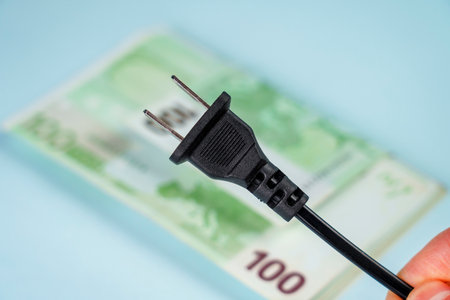 Disconnected American type electrical plug against the background of European cash money. global energy crisis conceptの写真素材