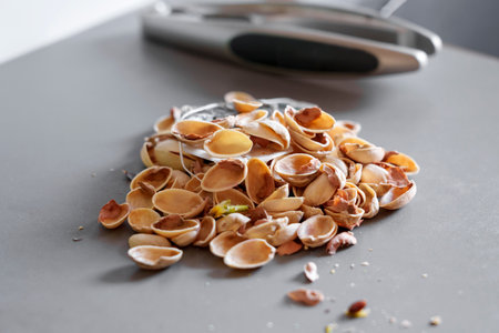A pile of kitchen scraps. Pistachio nutshell on the kitchen tableの写真素材