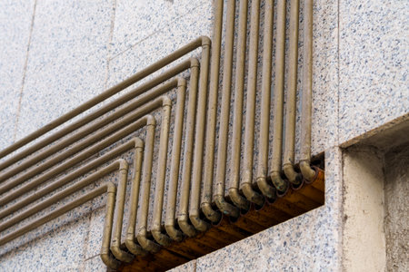 Gas pipes on exterior wall of a residential building closeup
