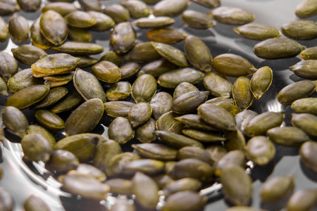 Green organic peeled pumpkin seeds close upの写真素材