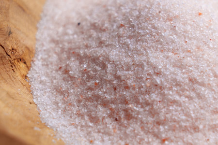 Crystals of fine pink Himalayan salt in a rustic bowl close upの写真素材
