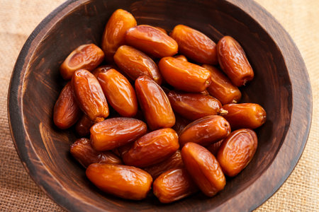 Dried date fruits in rustic wooden bowl. Sweet natural Turkish dessert. Organic product