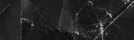 Abstract black folded old paper with wrinkles and defects. Aged used recycled cardboard. Grunge background for design and titlesの写真素材