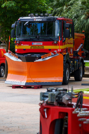 Oviedo, Spain - May, 25, 2024: A red heavy vehicle with a plow from a military emergency response...
