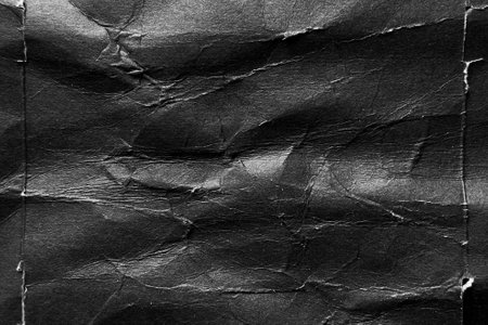 Black paper background with wrinkles, folds and crumpled distressed surface. Abstract grunge posterの写真素材