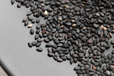 Heap of black sesame organic dry seeds on a ceramic surface. Uncooked spiceの写真素材