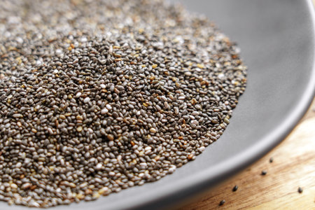 Dried chia seeds in a minimalist bowl, showcasing a natural organic superfood rich in nutrients. Ideal for clean eating, healthy diets and wellness-focused mealsの写真素材