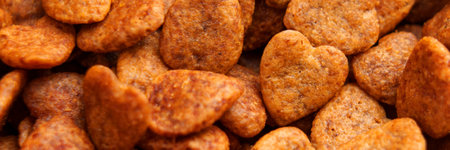 Crunchy cat treats in heart shapes with brown color. Textured and detailed view. Close upの写真素材