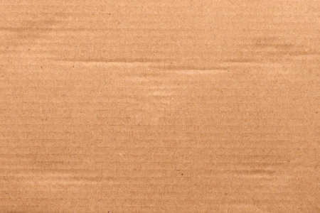 Brown corrugated cardboard with natural fibers and horizontal lines. Raw texture. Eco-friendly sustainable packaging. Abstract background. Rough surface of recycled materialの写真素材
