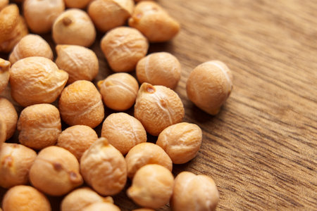 Raw chickpeas on wooden table surface. Macro shot.の写真素材