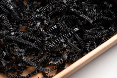 Delivery gift cardboard box with soft strips of shredded paper filling close upの写真素材