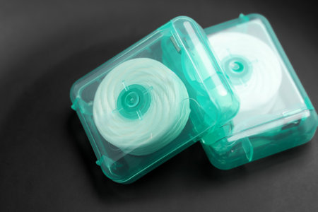 Dental floss on a black surface. Oral hygiene products close upの写真素材