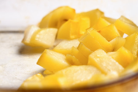 Freshly cooked roasted yellow potatoes in glass baking dish close upの写真素材