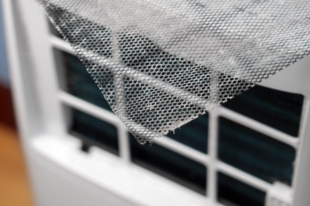 Dusty metal mesh of conditioner air purifier filter close up. Industrial maintenance service conceptの写真素材