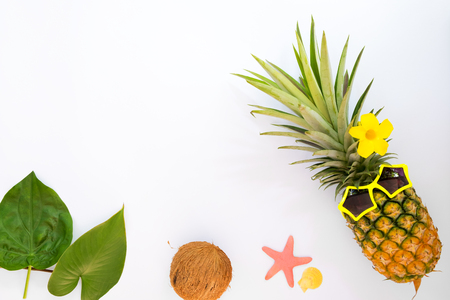 Hipster pineapple fashion with tropical fruit, sea shells and starfish. Summer vacation background concept. Top view, flat layの写真素材
