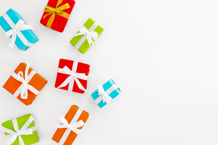 Christmas composition. Colorful Christmas gifts boxes on white backgrond. Creative flat lay, top view の写真素材