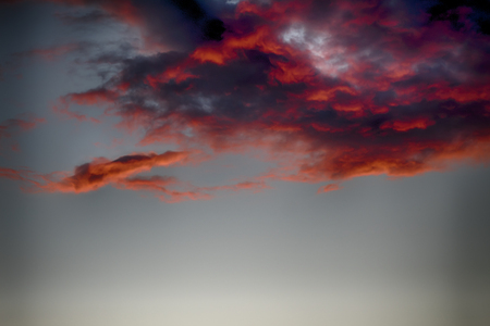 stormy, rainy cloud with a red bottom. reflected light of the setting sunの写真素材